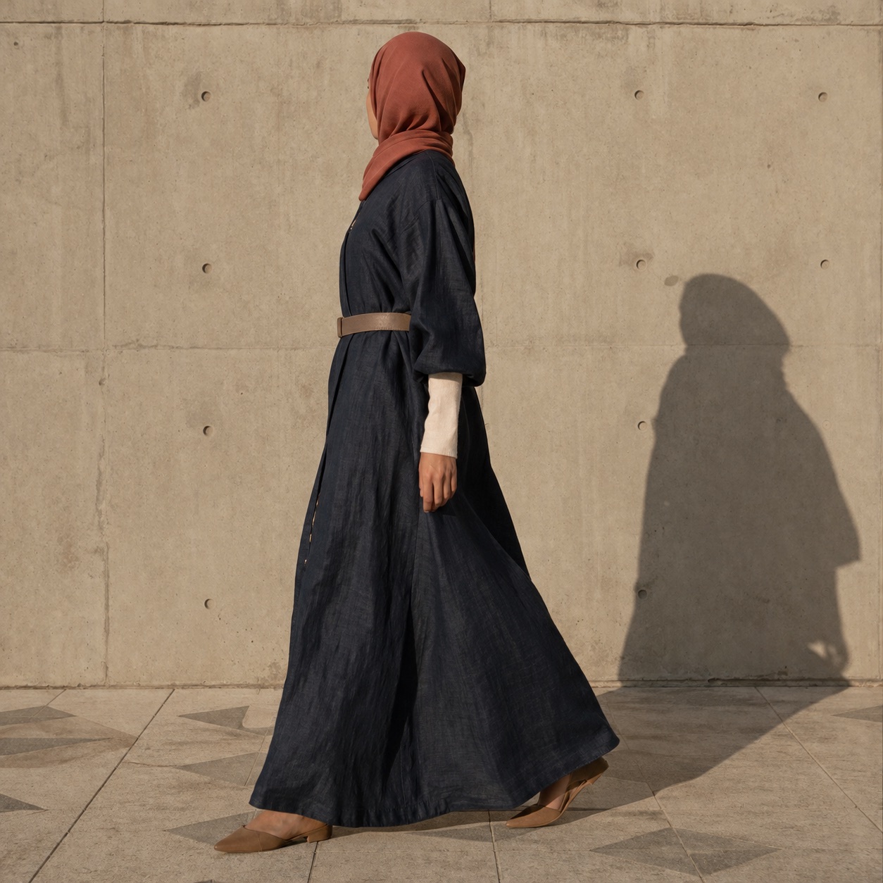 Fenwick closed abaya — Abayas & Robes by RUQYAH. worn by a model, side view.