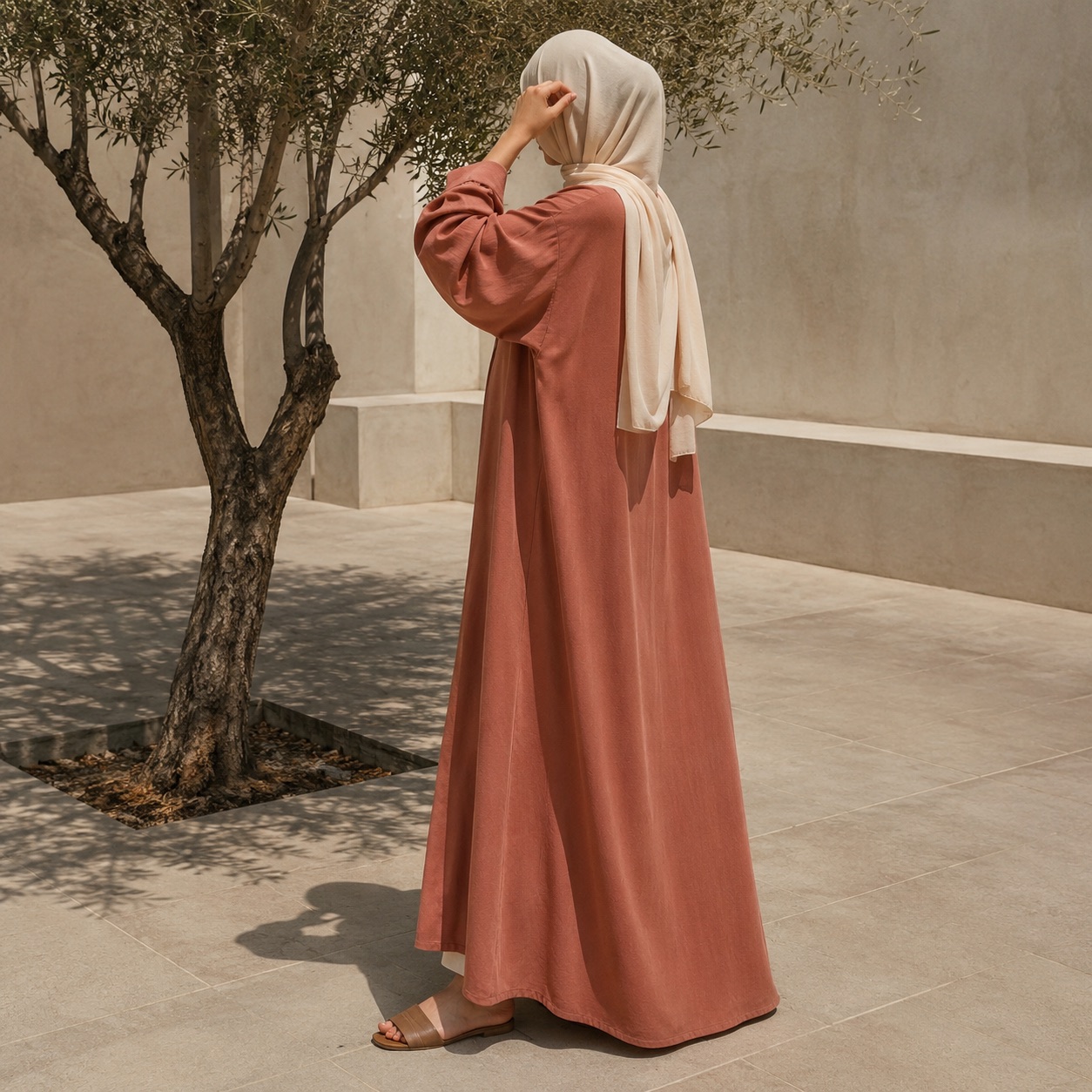 Granta open-front abaya — Abayas & Robes by RUQYAH. worn by a model, side view.