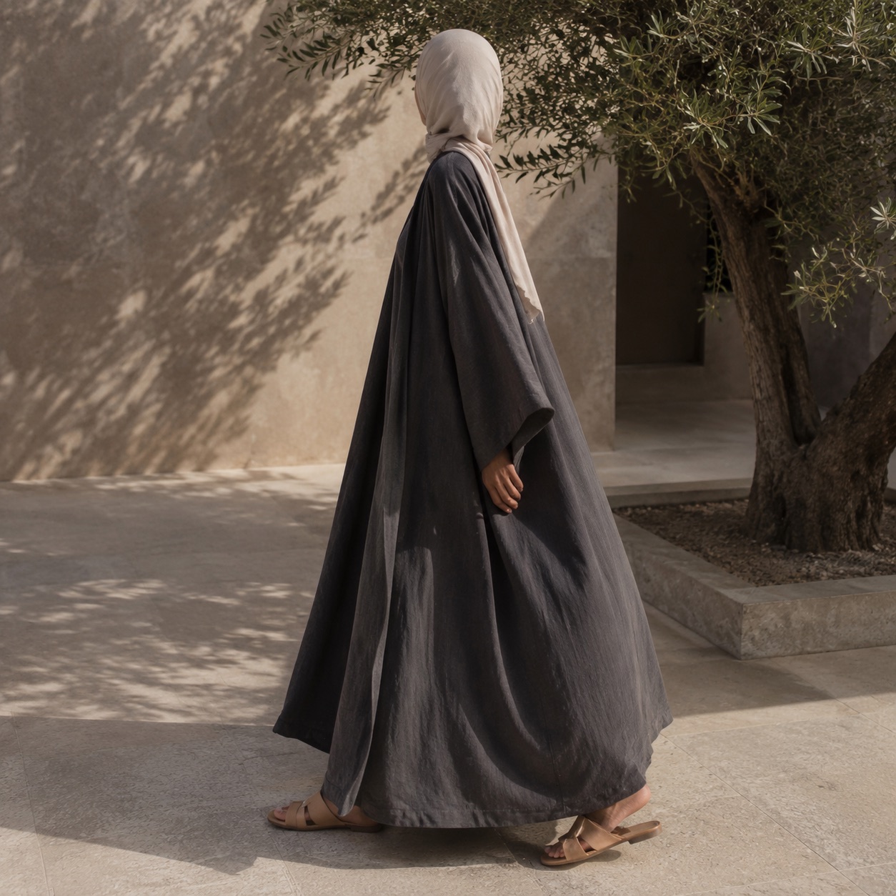 Purbeck open-front abaya — Abayas & Robes by RUQYAH. worn by a model, side view.